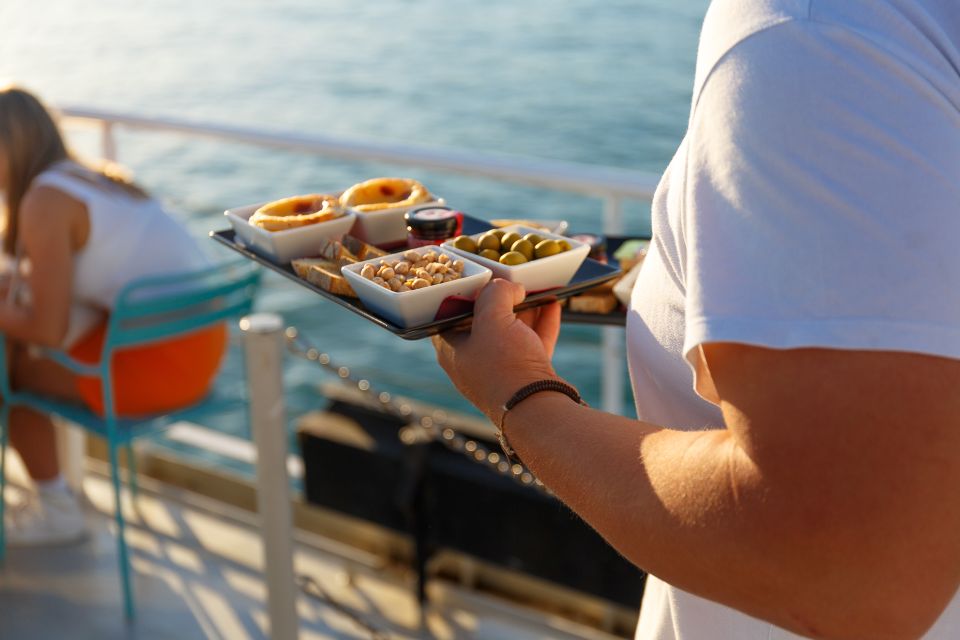 Lisbon: Tagus River Sunset Tour with Snacks and Drink - Audio guide: useful, but headphones are on you