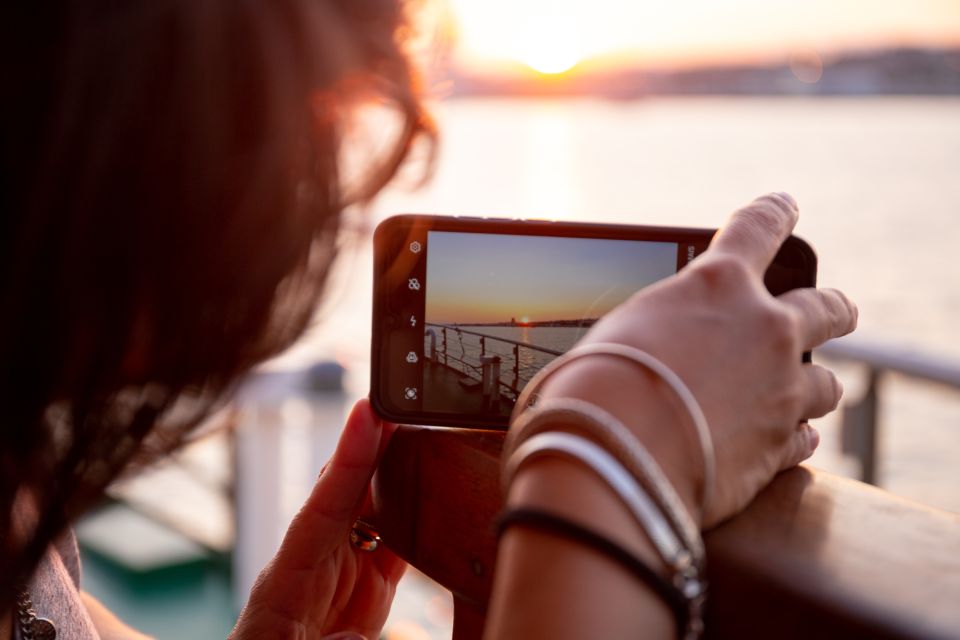 Lisbon: Tagus River Sunset Tour with Snacks and Drink - Onboard comfort: seating, bathrooms, and the vibe shift after sunset